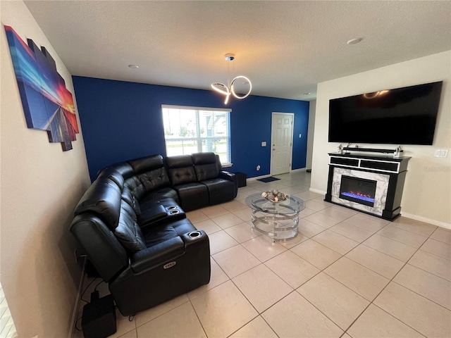 living room with a premium fireplace, light tile flooring, and a chandelier