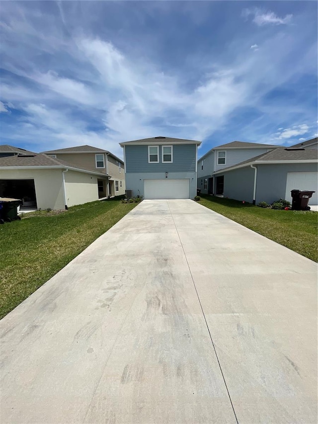 ranch-style house featuring a front lawn and a garage