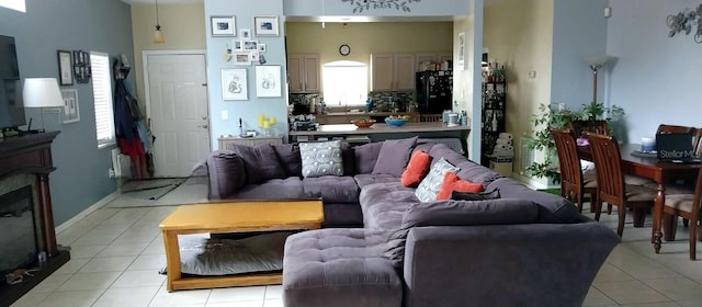 living room featuring light tile floors and sink