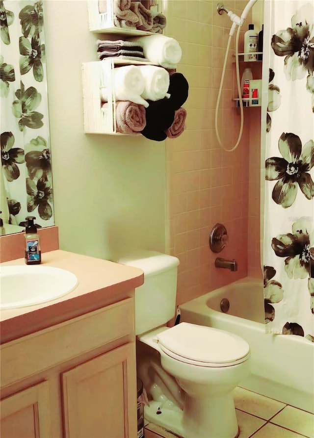 full bathroom with oversized vanity, toilet, shower / bath combo with shower curtain, and tile flooring