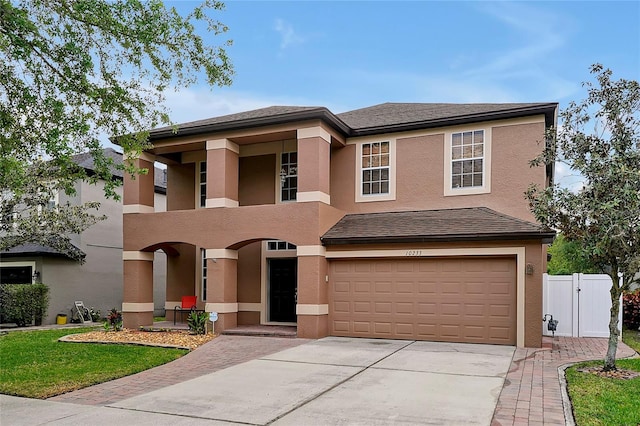 view of front of property with a garage and a balcony