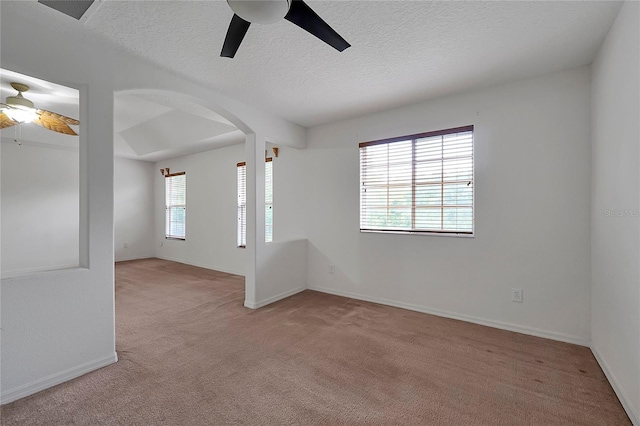 carpeted empty room featuring a textured ceiling and ceiling fan