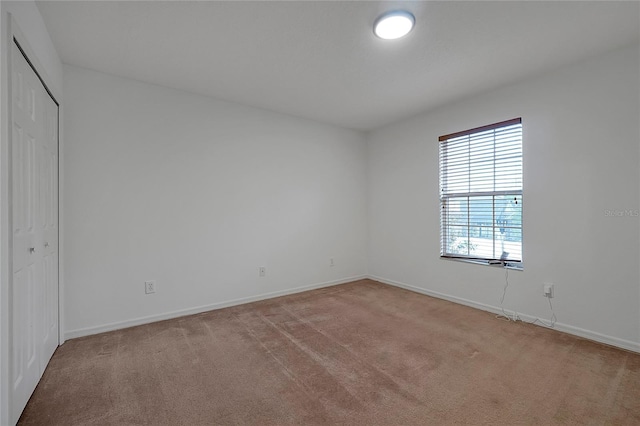 unfurnished room with light colored carpet