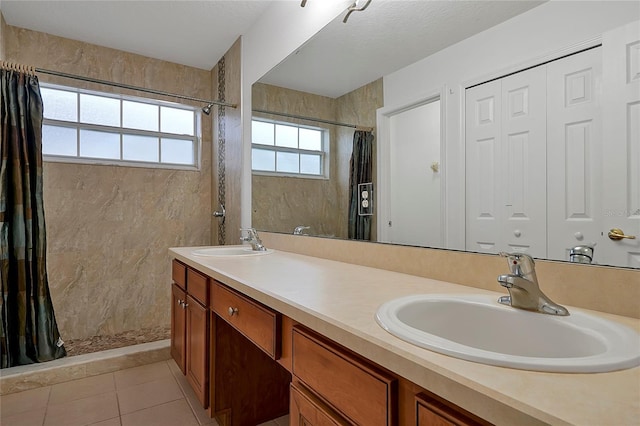 bathroom featuring vanity, tile patterned flooring, a textured ceiling, and a shower with shower curtain