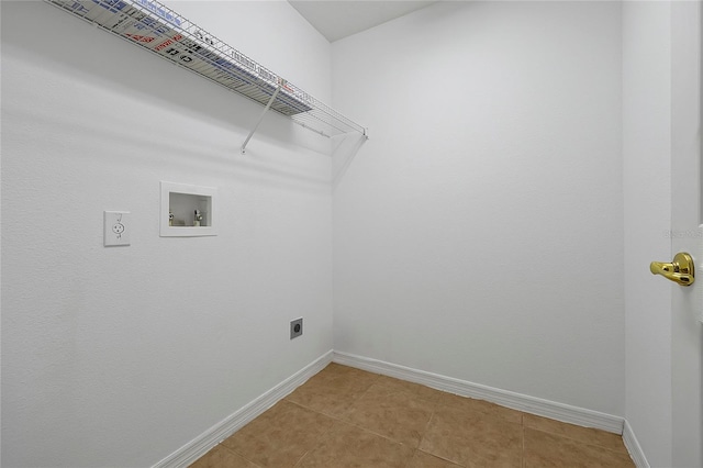 clothes washing area with hookup for a washing machine, hookup for an electric dryer, and light tile patterned floors