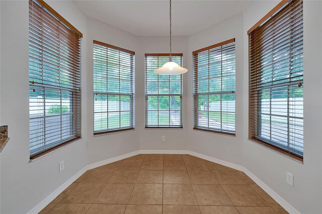 unfurnished dining area featuring light tile patterned floors