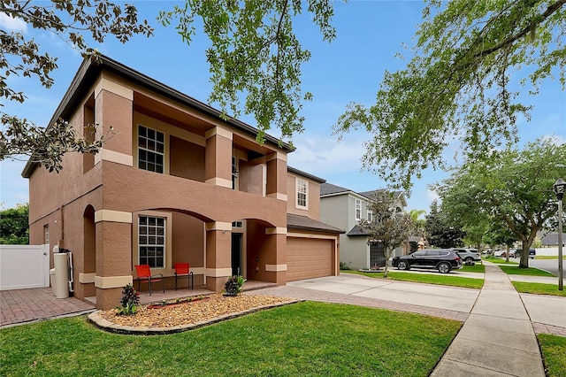 view of front of property with a garage and a front lawn