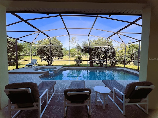 view of pool with a patio area and an in ground hot tub