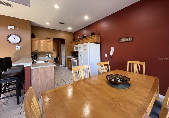 dining area with light tile floors and sink