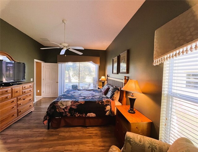 bedroom featuring dark wood-type flooring, access to outside, vaulted ceiling, and ceiling fan