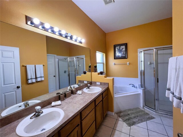 bathroom with tile floors, double sink, large vanity, and independent shower and bath