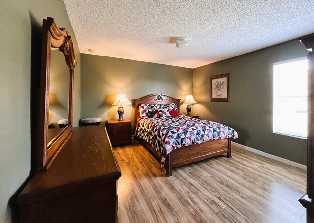 bedroom featuring a textured ceiling and light wood-type flooring