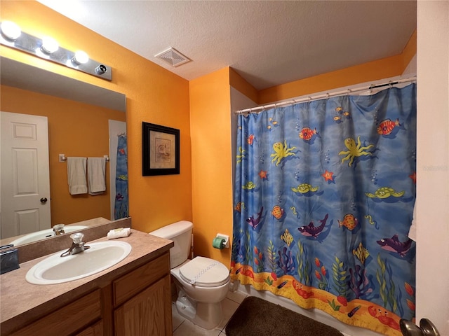 bathroom featuring vanity, tile flooring, a textured ceiling, and toilet