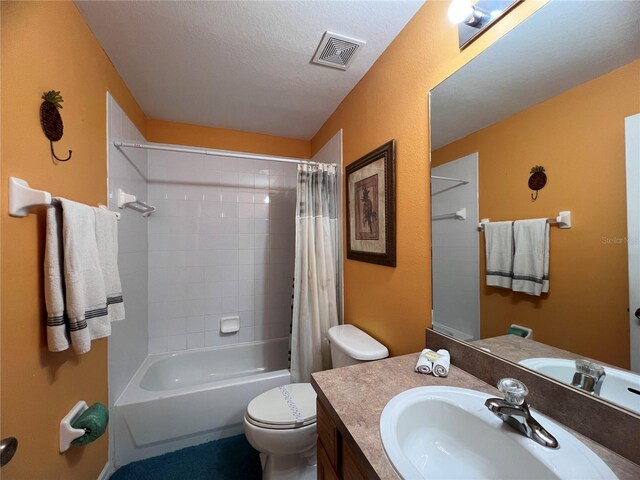 full bathroom featuring shower / bath combination with curtain, a textured ceiling, toilet, and vanity