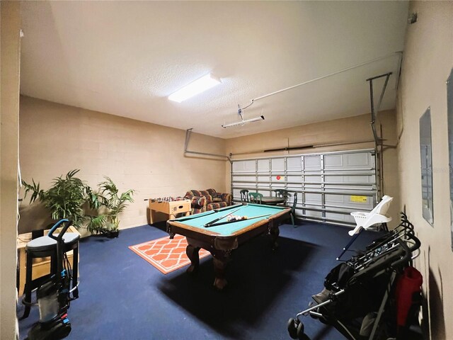 playroom with a textured ceiling and billiards