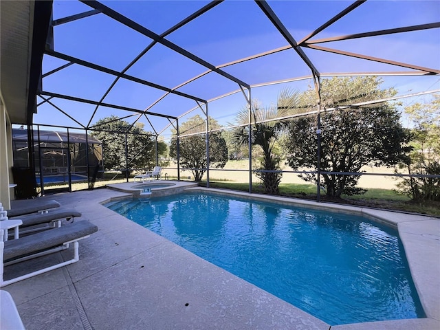 view of pool featuring an in ground hot tub, glass enclosure, and a patio