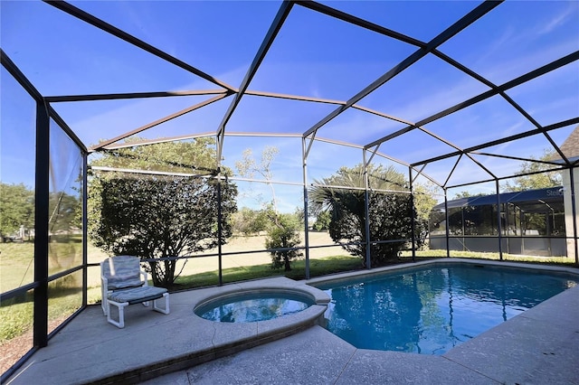 view of swimming pool with a lanai, a patio area, and an in ground hot tub