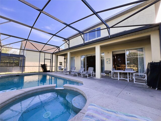 view of swimming pool featuring a patio and a lanai