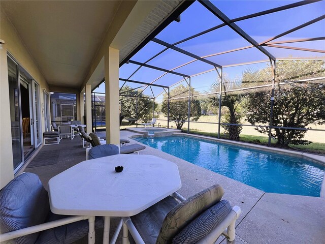 view of swimming pool with a patio and a lanai