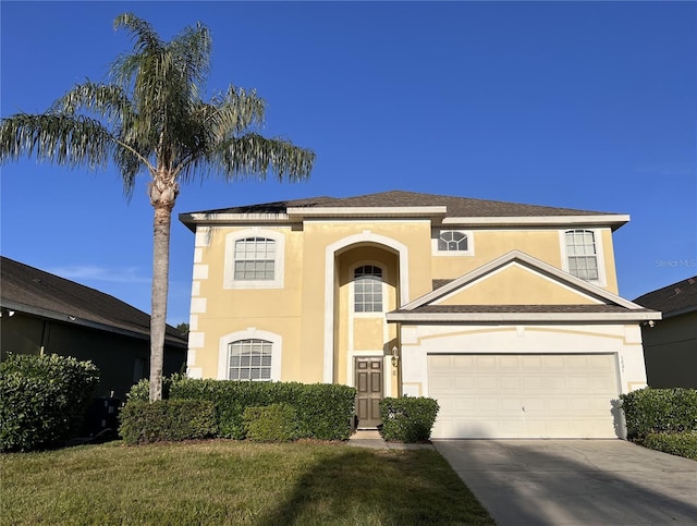 view of front of house with a front lawn and a garage