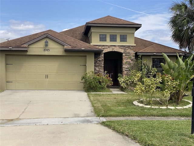 view of front of home featuring a garage and a front lawn