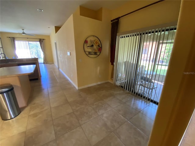 hall with light tile patterned floors