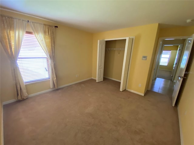 unfurnished bedroom with carpet flooring and a closet