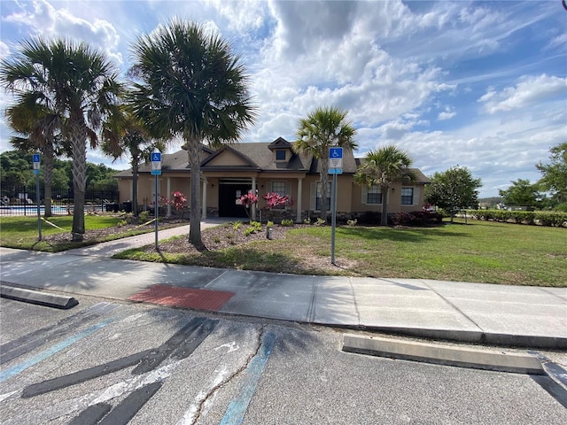 view of front of home with a garage and a front lawn