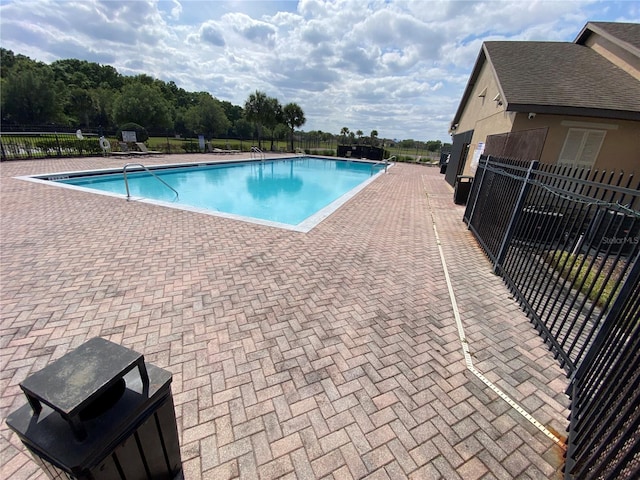 view of swimming pool with a patio area