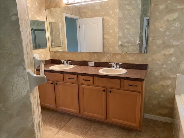 bathroom featuring tile patterned flooring, vanity, and a tub