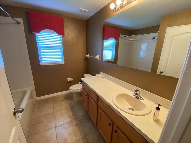 full bathroom featuring tile patterned floors, shower / tub combination, vanity, and toilet