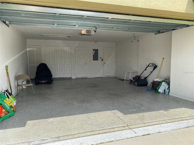 garage with electric panel and a garage door opener