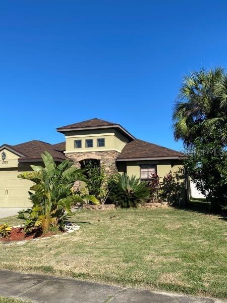 view of front of property featuring a front yard and a garage