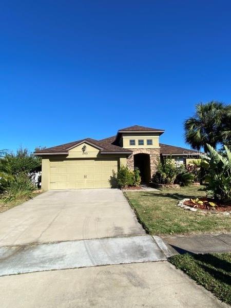 view of front of house featuring a garage and a front lawn