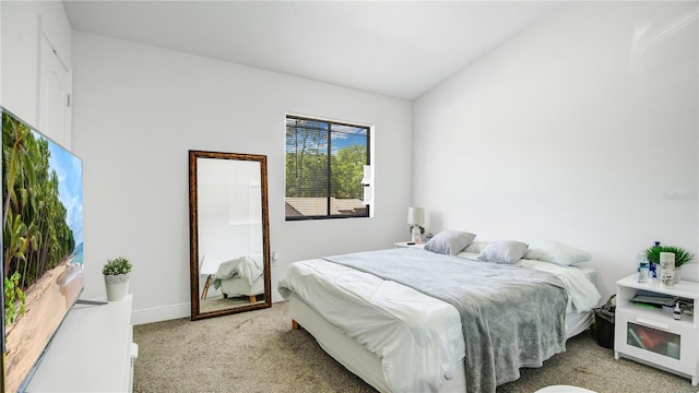 bedroom featuring light carpet and lofted ceiling