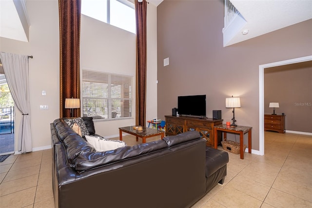 tiled living room with a high ceiling