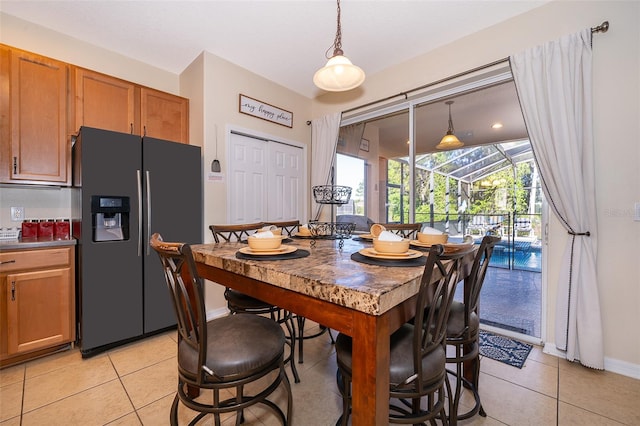 dining space featuring light tile floors