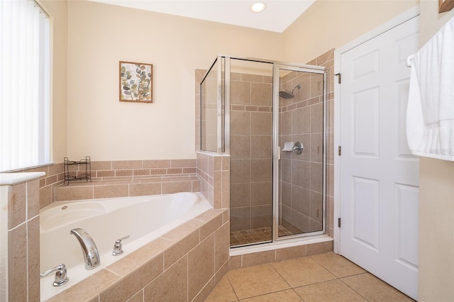 bathroom featuring tile floors and independent shower and bath