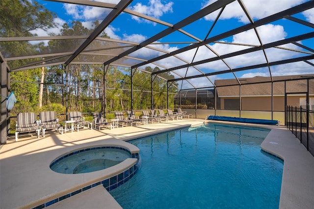 view of swimming pool with a patio area, glass enclosure, and an in ground hot tub