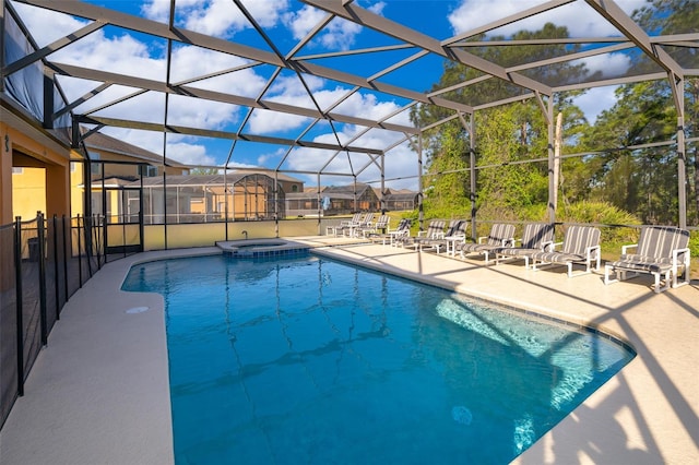 view of swimming pool with a patio area, a lanai, and an in ground hot tub