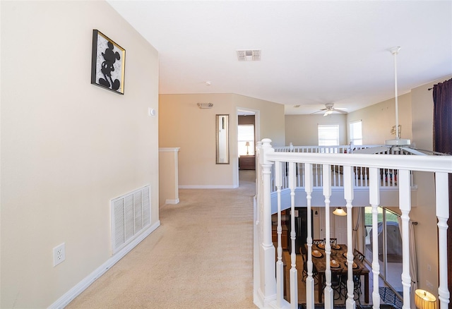 hallway with light carpet