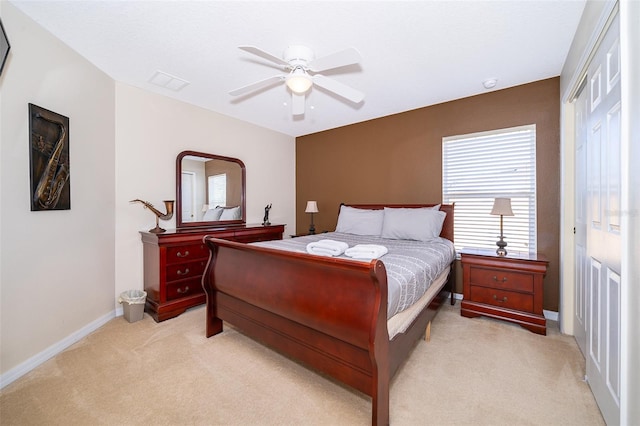 bedroom featuring a closet, ceiling fan, and light carpet