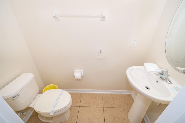 bathroom featuring tile floors and toilet