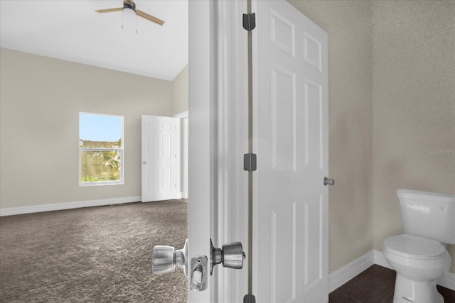 bathroom with ceiling fan and toilet