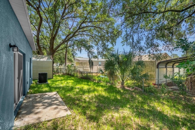 view of yard featuring a patio area, an outdoor structure, and central AC unit