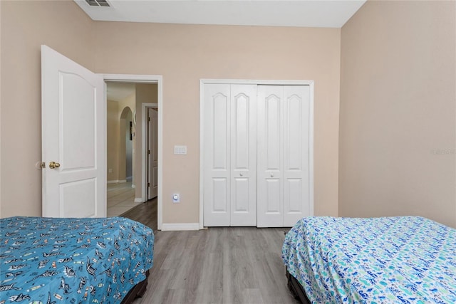 bedroom with a closet and wood-type flooring