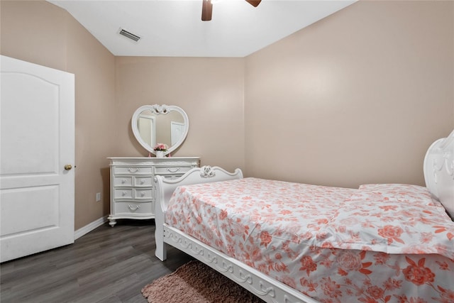 bedroom with dark hardwood / wood-style floors, vaulted ceiling, and ceiling fan