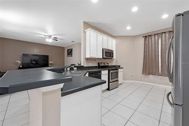 kitchen with ceiling fan, stainless steel appliances, white cabinets, sink, and kitchen peninsula