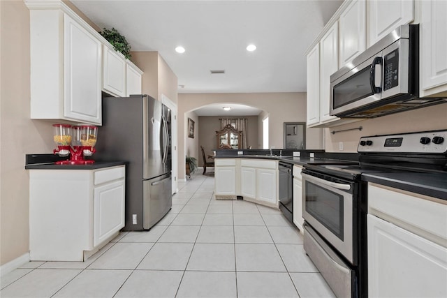 kitchen featuring white cabinets, light tile patterned flooring, and appliances with stainless steel finishes