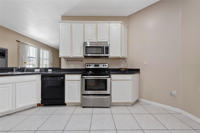 kitchen with white cabinetry, stainless steel appliances, sink, and light tile patterned floors